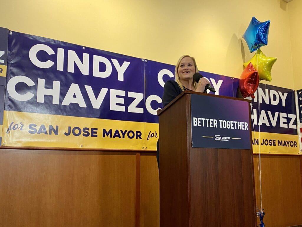 A woman standing at the podium of an event.