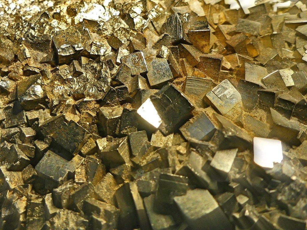 A close up of a pile of gold cubes.
