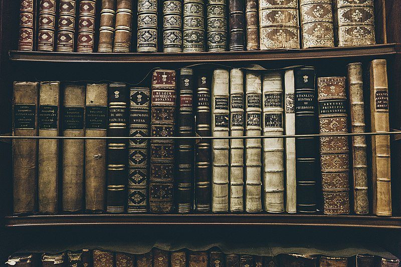Old books on a shelf in a library.