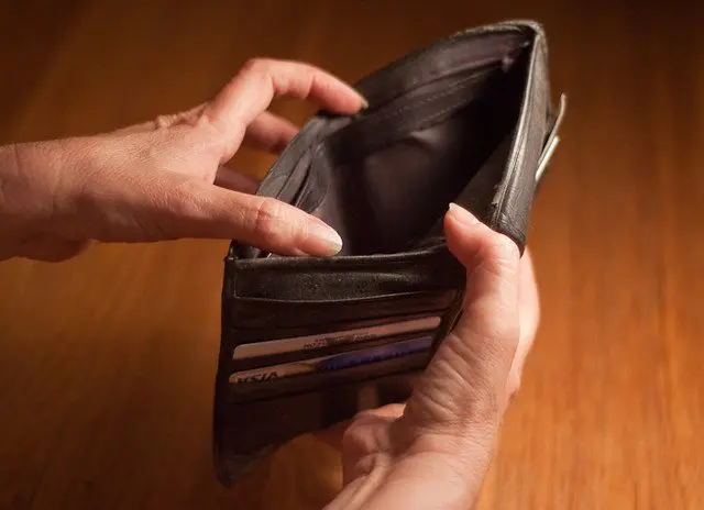 Empty wallet held open by two hands.