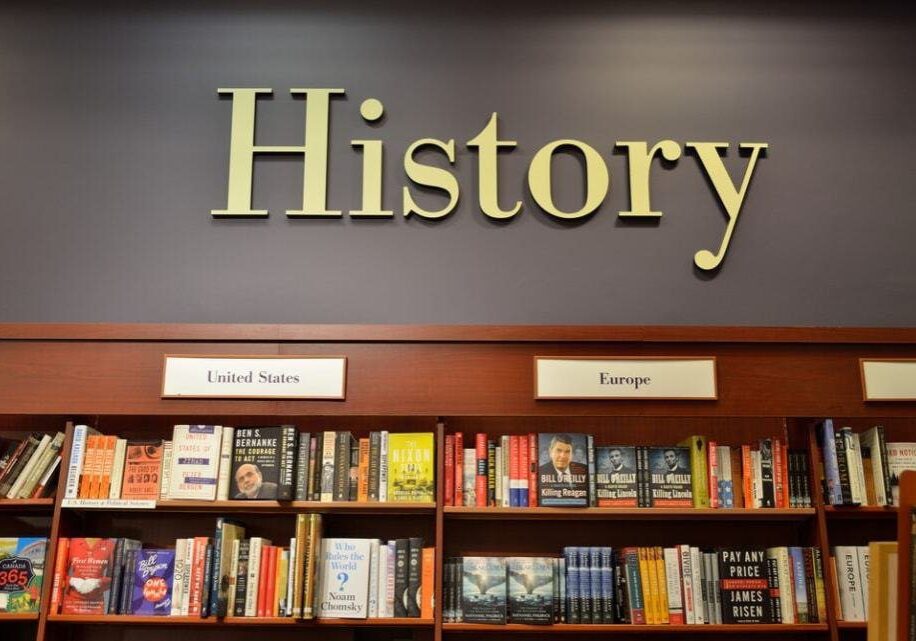 Bookshelf in a library labeled "history" with sections for united states and europe, filled with various history books.