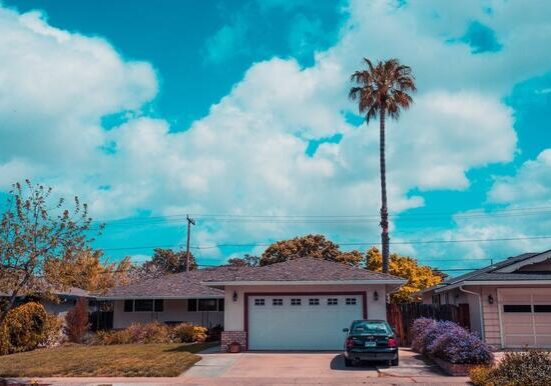 A house with a car parked in front of it.