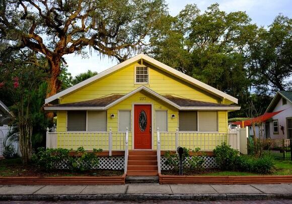 A yellow house with a red door.