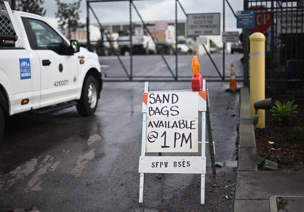 A sign that states, “Sand Bags Available @ 1 PM”